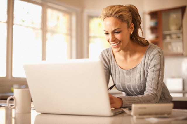 Hispanic woman typing on laptop